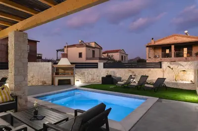 a backyard with a swimming pool and patio furniture at LUV Group of 4 Villas in Kathiana in Kathiana