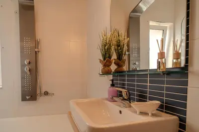 a bathroom with a sink and a mirror at Helena's Dream Home in Maleme