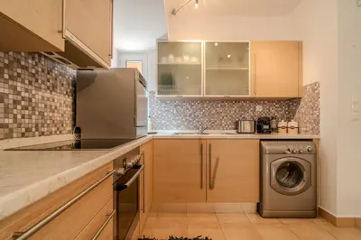 a kitchen with a washer and dryer in it at Helena's Dream Home in Maleme