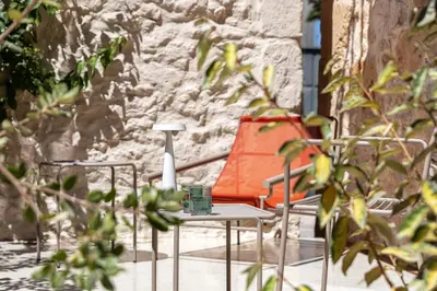 a table and chairs on a patio with a lamp at Hub Hospitality in Chania Town