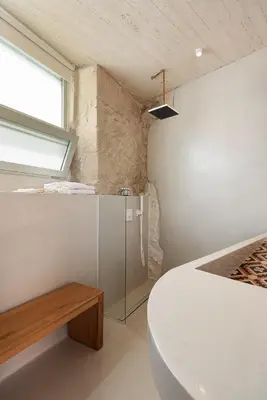 a bedroom with a bed and a bench and a window at Hub Hospitality in Chania Town