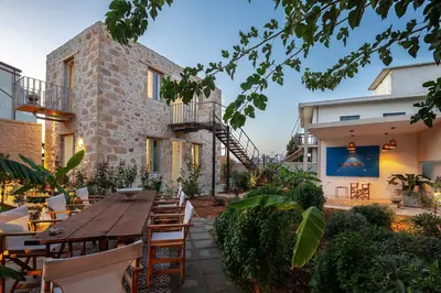 an outdoor patio with a wooden table and chairs at Hub Hospitality in Chania Town
