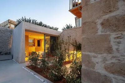 a stone house with a courtyard with plants at Hub Hospitality in Chania Town