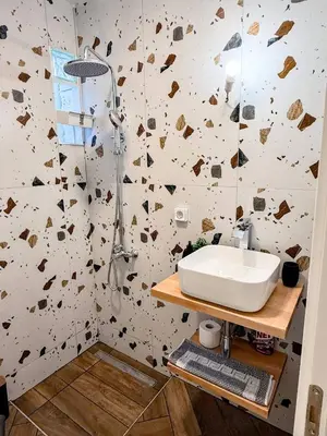 a bathroom with a sink and a shower at Amfitriti 30meter to beach, 6min Old Town, 2BD 4PL in Chania Town