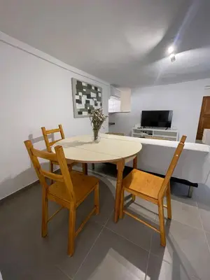 a dining room with a table and two chairs at Old Cellar House in Moní
