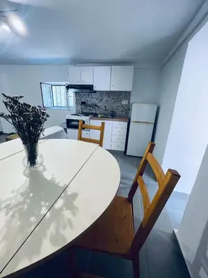 a kitchen with a table with a vase on it at Old Cellar House in Moní