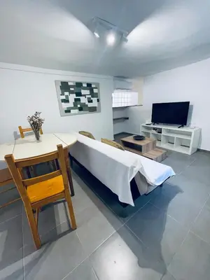 a living room with a bed and a television at Old Cellar House in Moní