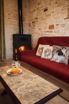 a living room with a couch and a table with a plate of food at Mersini Village in Milonianá