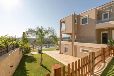 a house with a fence and a yard at Mystique Villa by Vintage Travel in Tavronitis