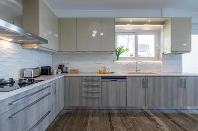 a large kitchen with white cabinets and a sink at Mystique Villa by Vintage Travel in Tavronitis