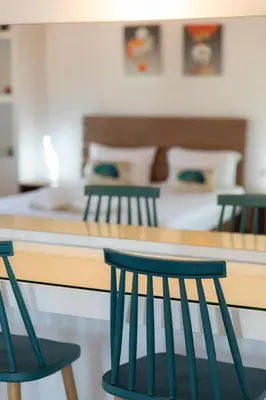 four green chairs sitting in front of a counter at Mystique Villa by Vintage Travel in Tavronitis