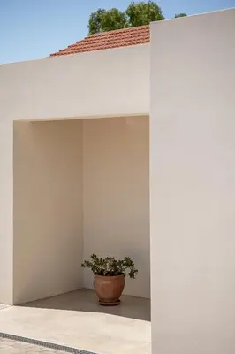 a plant in a pot sitting in the corner of a building at Myrtia Beach House in Tersanas