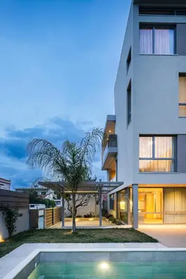 a house with a swimming pool next to a building at Alky Luxury Villa in Chania Town