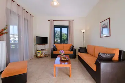 a living room with a couch and a table at Villa Alimedon in Almirida