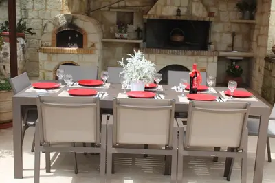 a dining room table with red plates and chairs at Villa Alimedon in Almirida
