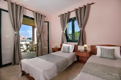 a bedroom with two beds and a balcony at Villa Alimedon in Almirida