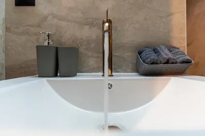 a bathroom sink with a faucet and two towels at A&G mare in Chania Town