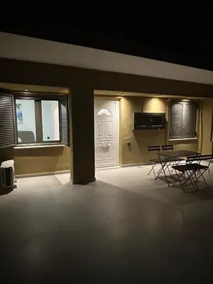a room with two chairs and a table and two windows at A&G mare in Chania Town