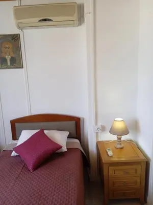 a bedroom with a bed and a table with a lamp at Marilu apartment in the center of Chania in Chania Town