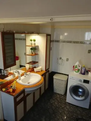 a bathroom with a sink and a washing machine at Marilu apartment in the center of Chania in Chania Town
