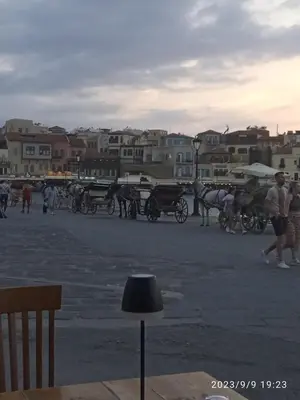 a group of horse drawn carriages in a parking lot at Marilu apartment in the center of Chania in Chania Town