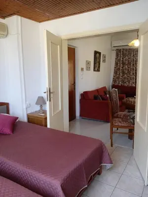 a bedroom with a bed and a living room at Marilu apartment in the center of Chania in Chania Town