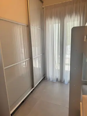 a living room with sliding glass doors and white curtains at Matthew's house in Kalamítsion Alexándrou