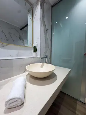 a bathroom with a large bowl sink on a counter at Deluxe Center Suites in Chania Town