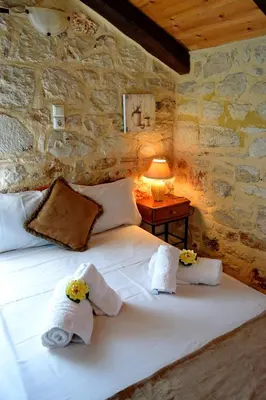 a bedroom with a bed with towels on it at Chania's Diamond Villas - Aqua Bliss with Private Pools in Gavalochori