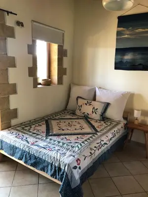 a small bed in a room with at Apartment in natural stone house in Spiliá