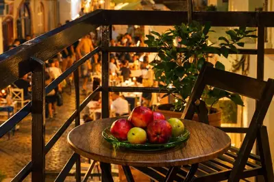 a bowl of apples sitting on a wooden chair at Gardenia Maisonette Rooftop Old Town View in Chania Town