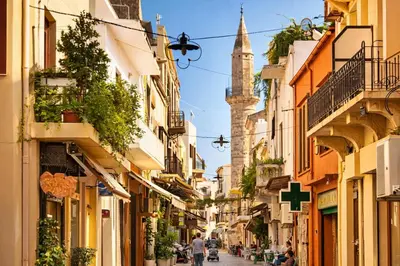 a street in a city with a mosque in the background at Gardenia Maisonette Rooftop Old Town View in Chania Town