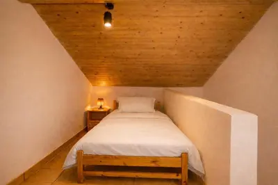 a small bedroom with a bed in a attic at Gardenia Maisonette Rooftop Old Town View in Chania Town