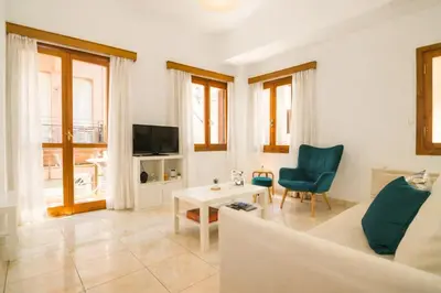 a living room with a couch and a table at Gardenia Maisonette Rooftop Old Town View in Chania Town