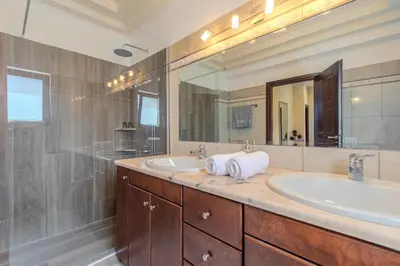 a bathroom with two sinks and a large mirror at Anna by Vintage Travel in Troúlous