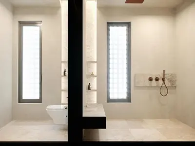 a bathroom with a toilet and a sink and two windows at The Revery, Elafonisi - Member of Leading Hotels of the World in Livadia