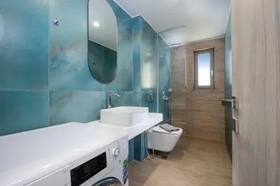 a bathroom with a sink and a toilet and a mirror at Villa Sea Breeze in Xamoudhokhórion
