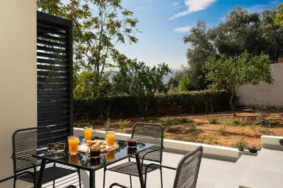 a table and chairs on a patio with a view at Ethea Residences-Thalia in Chania Town