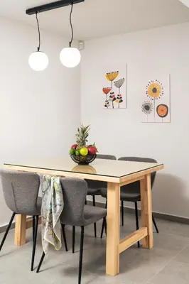 a dining room table with chairs and a bowl of fruit on it at Ethea Residences-Thalia in Chania Town