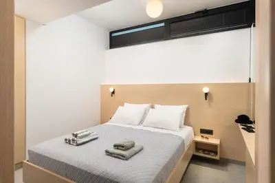 a bedroom with a bed with towels on it at Ethea Residences-Thalia in Chania Town