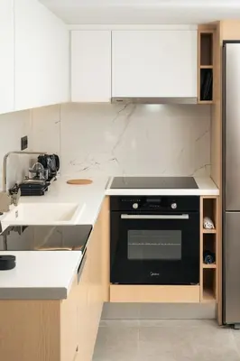 a kitchen with white counters and a black oven at Ethea Residences-Thalia in Chania Town