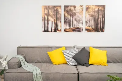 four paintings on a wall above a couch at Ethea Residences-Thalia in Chania Town