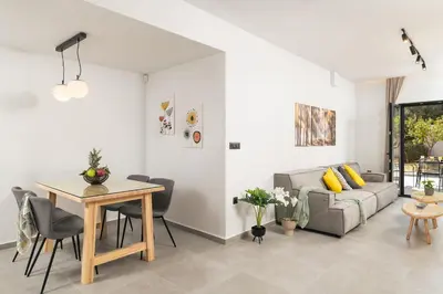 a living room with a table and a couch at Ethea Residences-Thalia in Chania Town