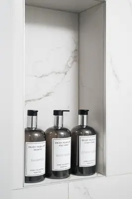 three bottles of soap sitting on a shelf at Ethea Residences-Thalia in Chania Town