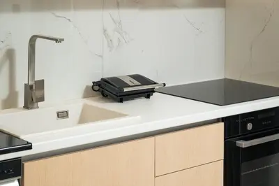 a kitchen with a sink and a counter top with a appliance at Ethea Residences-Helia in Chania Town