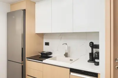a kitchen with a sink and a refrigerator at Ethea Residences-Orino in Chania Town