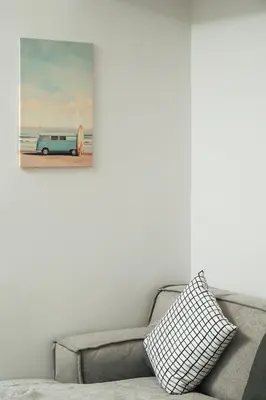 a couch in a living room with a picture of a van at Ethea Residences-Orino in Chania Town