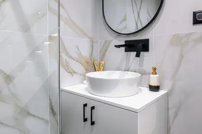 a bathroom with a sink and a mirror at Peonia Apartment Modern Two-Level Stay Near Old Town in Chania Town