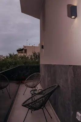 two chairs and a table on a balcony at MP Apartments in Chania Town