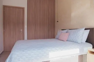a bedroom with a large bed with wooden cabinets at MP Apartments in Chania Town